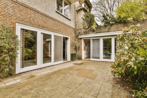 a-brick-house-with-a-patio-and-some-windows-2023-06-09-20-44-16-utc-2